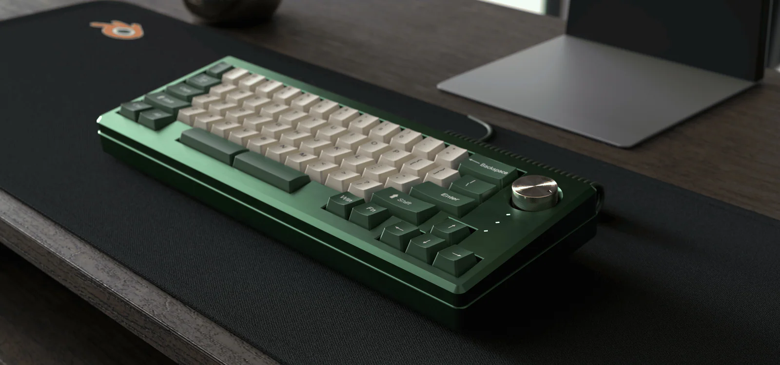 Synapse keyboard in forest green, cream keycaps and brass knob, on a walnut desk